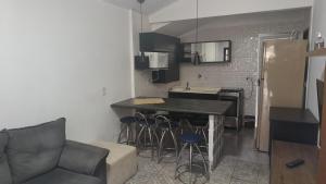 eine Küche mit einem Tisch und Stühlen im Zimmer in der Unterkunft Espaço Casa Branca in Caraguatatuba