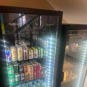a refrigerator filled with lots of sodas and drinks at UH 1116 Flat Live Logde Vila Mariana in Sao Paulo
