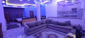 ein Wohnzimmer mit einem Sofa in einem Zimmer in der Unterkunft فندق الفخامة in El-Qaṭṭa