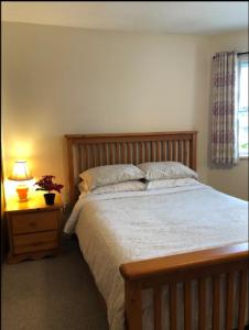 een slaapkamer met een bed en een lamp op een nachtkastje bij Private 1 bedroom 1 bath with separate entrance in a house in Burnaby