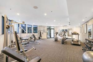 a gym with treadmills and machines in a building at Studio with Resort Facilities in Prime Location in Gold Coast