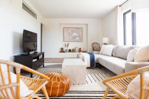 a living room with a couch and a tv at Old Milford - Modern Home 5 Minutes from Picton in Picton