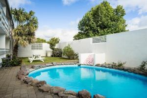 a swimming pool in the backyard of a house at Marsden Stay Rotorua in Rotorua