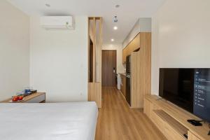 a bedroom with a bed and a flat screen tv at 22Housing Luxury Apartment 81 Linh Lang in Hanoi