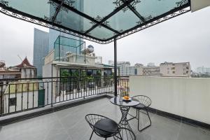 a balcony with a table and chairs on a building at 22Housing Luxury Apartment 81 Linh Lang in Hanoi