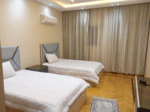 a hotel room with two beds and a window at شقق فندقية فاخرة in Cairo