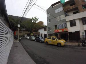 a yellow car parked on the side of a city street at Right in the heart of Medellin in Medellín