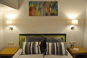 a bedroom with a bed with a painting on the wall at Bomb Shelter apartment in Vilnius
