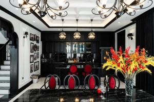 a dining room with red chairs and a table at Villa - Biệt Thự Nghĩ Dưỡng Hạ Long in Ha Long