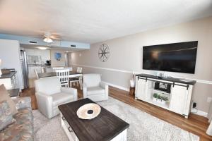 a living room with a large flat screen tv at 0802 Waters Edge Resort condo in Myrtle Beach