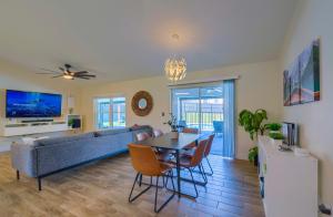 a living room with a couch and a table and chairs at New Resort Style Oasis ~ LED Pool & Game Room in Minneola
