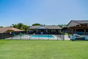 a fence around a swimming pool in a yard at New Resort Style Oasis ~ LED Pool & Game Room in Minneola