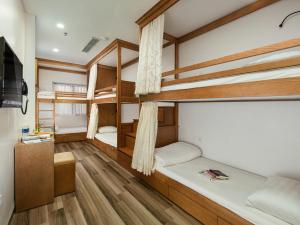 a room with two bunk beds and a flat screen tv at Affa Boutique Hotel in Hanoi