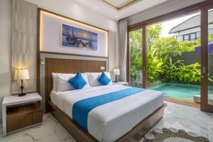 a bedroom with a bed and a swimming pool at Villa Sun Lila by JB Villas in Seminyak