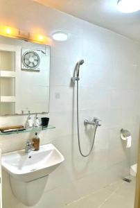 a bathroom with a toilet and a sink and a shower at Nice room located right next to the Old Quarter Căn phòng nhiều ánh sáng tại ngay gần phố đi bộ Hồ Gươm in Hanoi