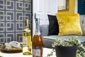 a bottle of wine on a table in a living room at Platinum Grove B Modern Flat, 2 Beds with Free Parking in Kent