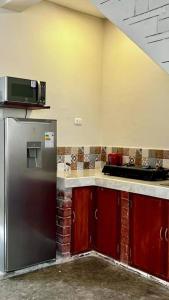 a kitchen with a stainless steel refrigerator and a microwave at Estreno: Cómodo y céntrico Dpto. en Caraz Dulzura. in Caraz