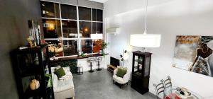a living room with a couch and a window at NYC Loft Brisbane, Free Parking! in Brisbane