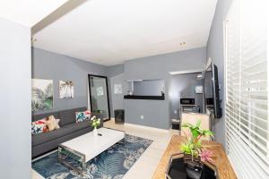 een woonkamer met een bank en een tafel bij Sunny Days Apartments in Miami Beach