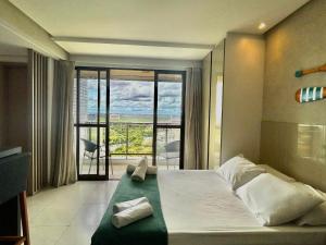 a bedroom with a large bed with a large window at (903) Studio exclusivo e clima tropical in Vinhais +74 photos