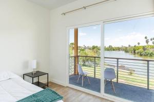 a bedroom with a large window with a view of the water at Waterfront Oasis with Bunk Room by SpaceX and SPI in Brownsville