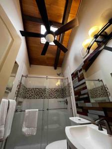 a bathroom with a ceiling fan and a shower at Modern Kahana getaway in Kahana