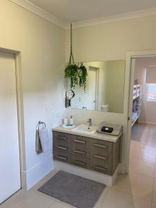 a bathroom with a sink and a mirror at 35 Bluefin Cove in Exmouth