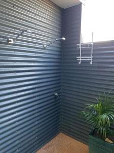 una pared de metal con una puerta de metal con una planta en 35 Bluefin Cove, en Exmouth