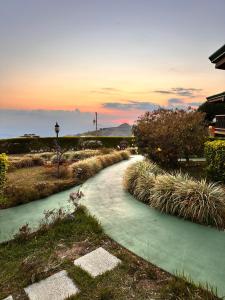 a walkway leading to a house with the sunset in the background at Hotel Trópico Monteverde in Monteverde Costa Rica