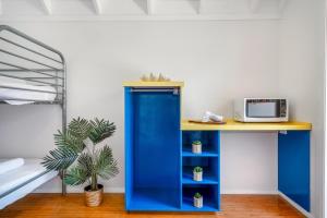 a blue desk with a microwave on top of it at BIG4 Tasman Holiday Parks - Nambucca Heads in Nambucca Heads +147 photos