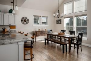 a kitchen and dining room with a table and chairs at Southbridge Cottage: Cozy and Modern Home in Bozeman