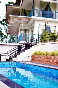 a swimming pool in front of a building at Paadi Holidays Idukki in Idukki