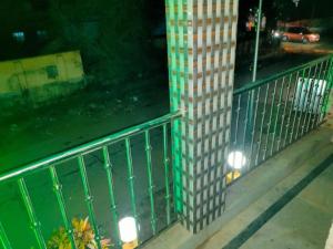 a building with a fence next to a street at night at Hotel Milan Guest House Digha - Couple Friendly in Digha