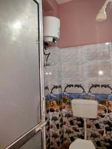 a bathroom with a toilet and a shower at Hotel Milan Guest House Digha - Couple Friendly in Digha