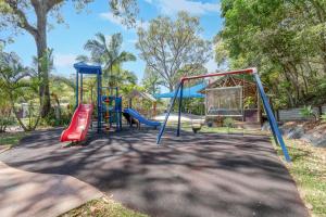 a playground with slides and swings at BIG4 Tasman Holiday Parks - Nambucca Heads in Nambucca Heads
