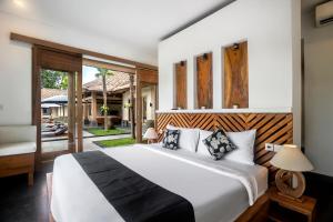 ein Schlafzimmer mit einem großen Bett und einer Terrasse in der Unterkunft Villa Jepun by BaliSuperHost in Ubud