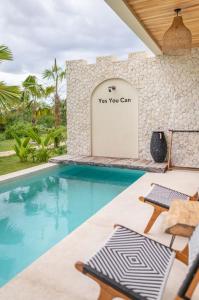 a pool with chairs and a sign that says way you can at Stylish Tropical Villa in Uluwatu in Uluwatu
