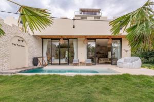 a house with a swimming pool in the yard at Stylish Tropical Villa in Uluwatu in Uluwatu