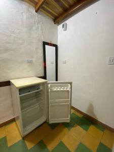 an empty room with a refrigerator and a counter at Apartaestudio cerca a parque Zapatoca in Zapatoca