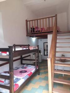a room with three bunk beds and a staircase at Apartaestudio cerca a parque Zapatoca in Zapatoca
