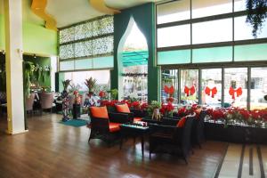 a lobby with chairs and flowers in a mall at Anantra Pattaya Resort in Pattaya Central