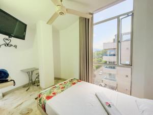 a bedroom with a bed and a large window at Hotel Macedonia Plaza Itagui in Medellín +45 photos
