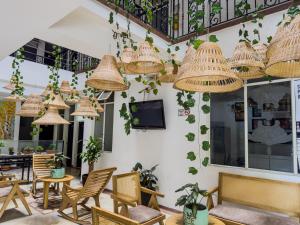 a room with chairs and rattan lights at Hotel Macedonia Plaza Itagui in Medellín
