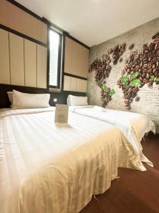 a bedroom with two beds with a sign on it at Chariton Hotel Nusa Bestari in Johor Bahru