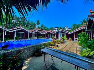 a villa with a swimming pool in a resort at The Four Season Hotel & Cottage, Goa in Candolim
