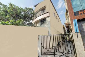 a building with a gate in front of it at Raman Dormitory in Navi Mumbai