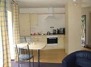 a kitchen with a table and chairs in a living room at Haus Fernsicht in Husum