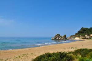 a view of a beach with the ocean at Pool Apartments with panoramic Pelekas Beach view in Pelekas