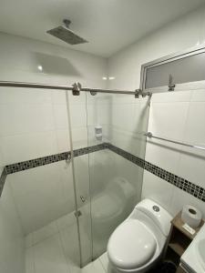 a bathroom with a glass shower and a toilet at Emporium Medellín Laureles in Medellín