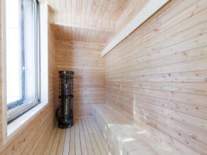 a sauna with wood paneling and a window at Tabist Kitami Athlete Stays in Kitami